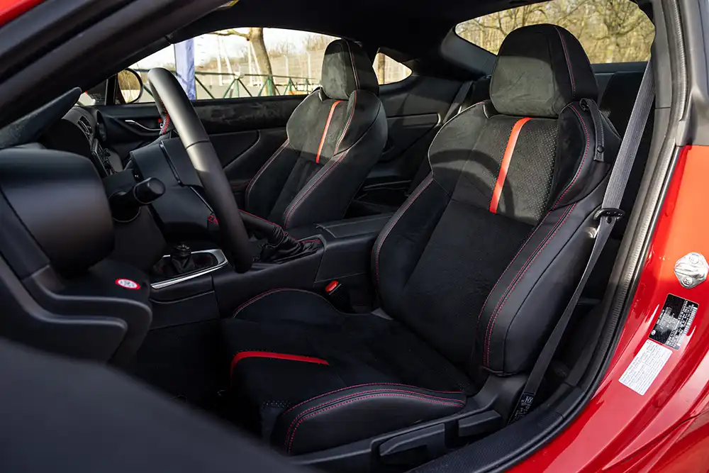 Passgenau: Die Sportsitze mit einem Bezug-Mix aus Leder und Ultrasuede und roten Kontraststreifen.
