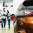 Young couple buying a new car in dealership