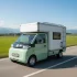 Der Ari 458 Pro Elektro-Transporter mit weißem Camping-Kofferaufbau fährt auf einer Landstraße – Ideal als günstiges Mini-Wohnmobil.