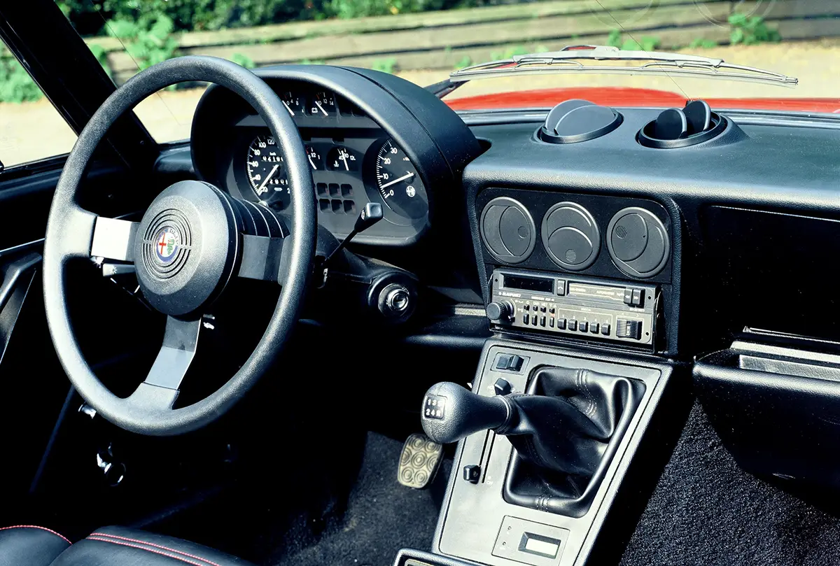 Modernisiertes Cockpit des Alfa Spider der dritten Serie (1983) mit schwarzem Kunststoff-Interieur.
