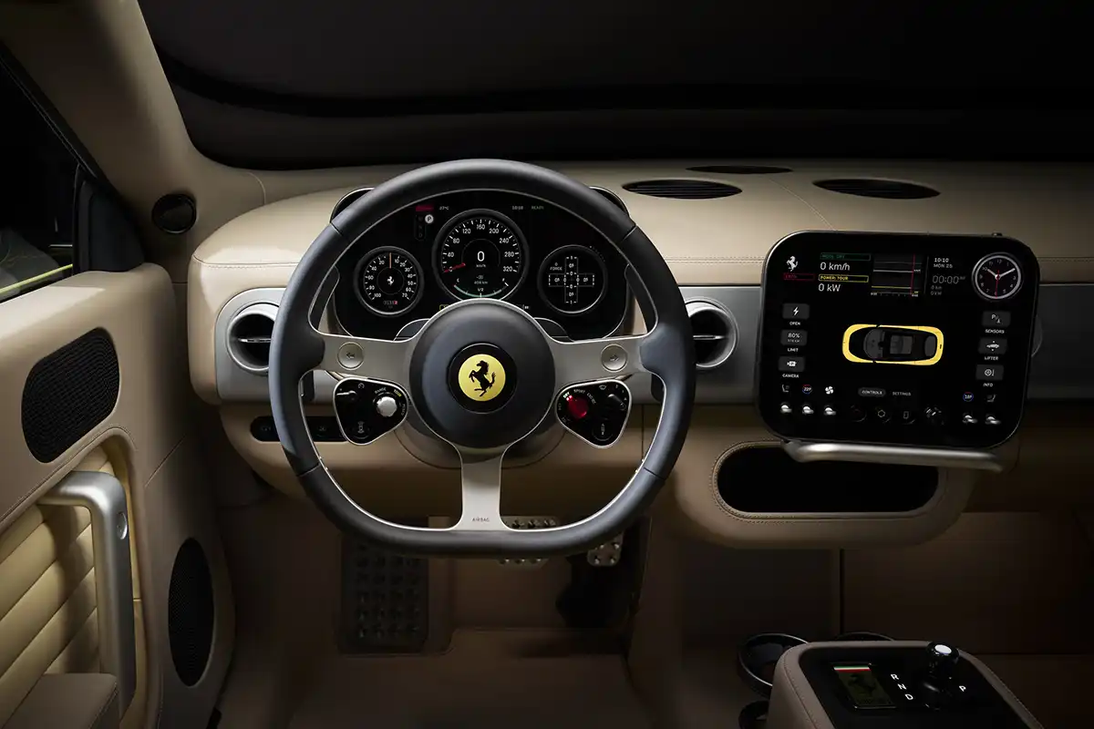 Blick in das retro-futuristische Cockpit des E-Ferraris mit dem dreispeichigen Lenkrad, physischen Kippschaltern und dem an der Lenksäule montierten Digitaldisplay.