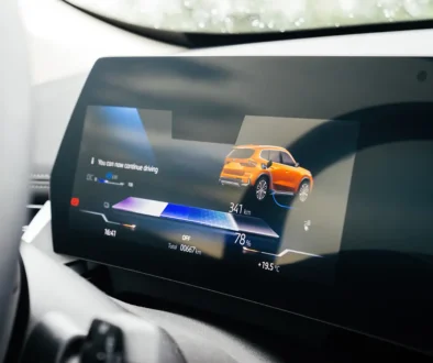 Ein neues Elektroauto von BMW wird aufgeladen; auf dem Armaturenbrett werden eine Reichweite von 667 Kilometern und eine Außentemperatur von 19,5 Grad Celsius angezeigt. Foto: ifeelstock - stock.adobe.com