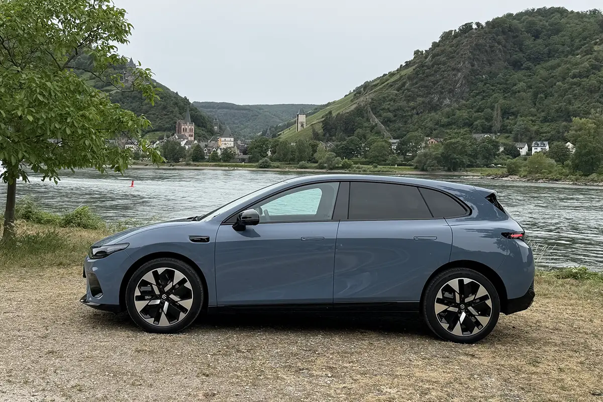 Die vollständige Profil-Seitenansicht des Leapmotor B05 vor einem Fluss zur Veranschaulichung der aerodynamischen, kompakten SUV-Silhouette und der zweifarbigen Alufelgen.