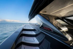 Close-up of a Brabus yacht engine cover on a sleek motor yacht, with the calm blue ocean in the background.