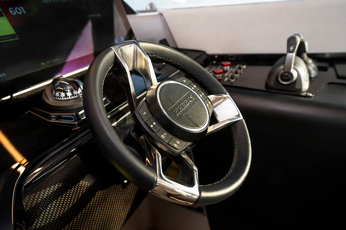 Detailaufnahme des Carbon-Steuerstands der BRABUS ULTIMA 55 mit Leder-Sportlenkrad, Kompass und Doppel-Gashebel. Foto: Brabus