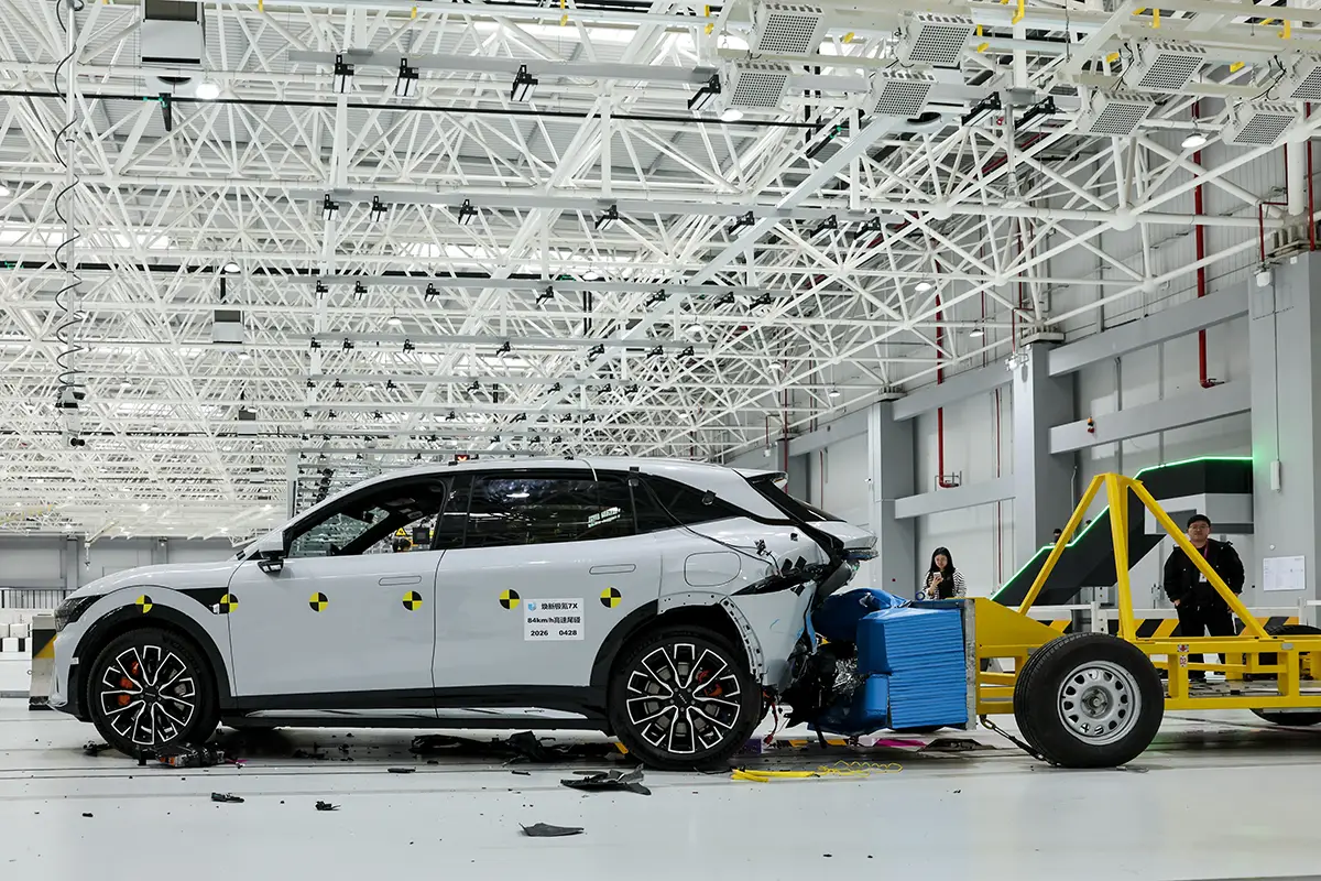 Ein weisser Crossover im Heck-Crashtest des Geely ECRI Testzentrums beim Aufprall einer mobilen Barriere.