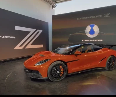 Ein flacher, sportlicher roter Denza Z Supersportwagen steht im BYD-Ausstellungspavillon vor einer Wand mit einem beleuchteten Marken-Logo beim Goodwood Festival of Speed 2026.