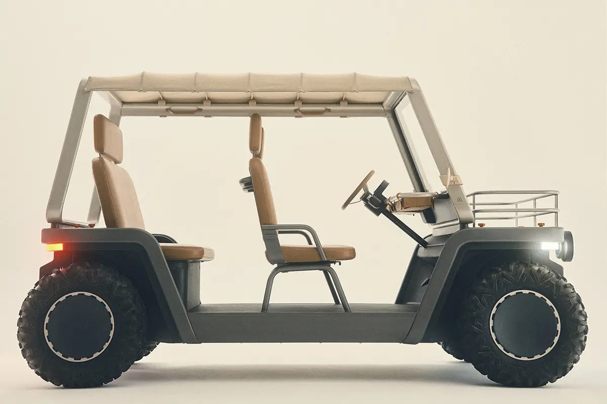 Seitenprofil des minimalistischen, grauen Elektro-Buggy Amble One der Klasse L7e mit grobstolligen Offroad-Reifen, offenem Rohrrahmen-Dach und braunen Sitzen.