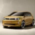 Gold-gelbes Konzeptfahrzeug des VW ID Up Elektro-Kleinstwagens mit markanter Frontpartie und LED-Lichtsignatur im Fotostudio.