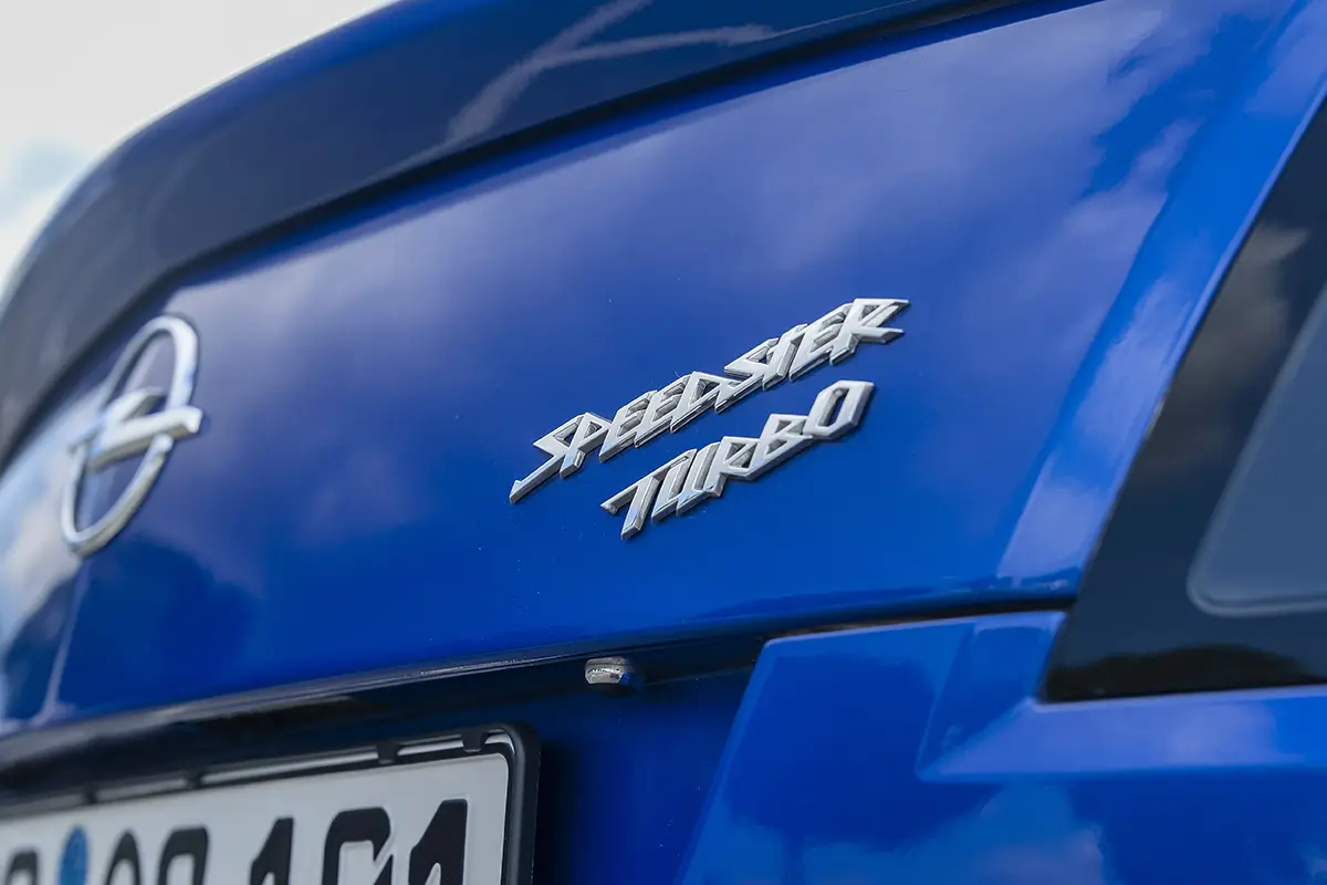 Detailaufnahme des verchromten Speedster Turbo Modellschriftzugs auf dem blauen Heckdeckel.