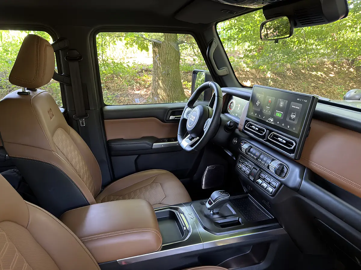 Moderner Innenraum des BAW 212 mit braunen Ledersitzen, digitalem Instrumenten-Cluster und grossem zentralen Infotainment-Touchscreen.