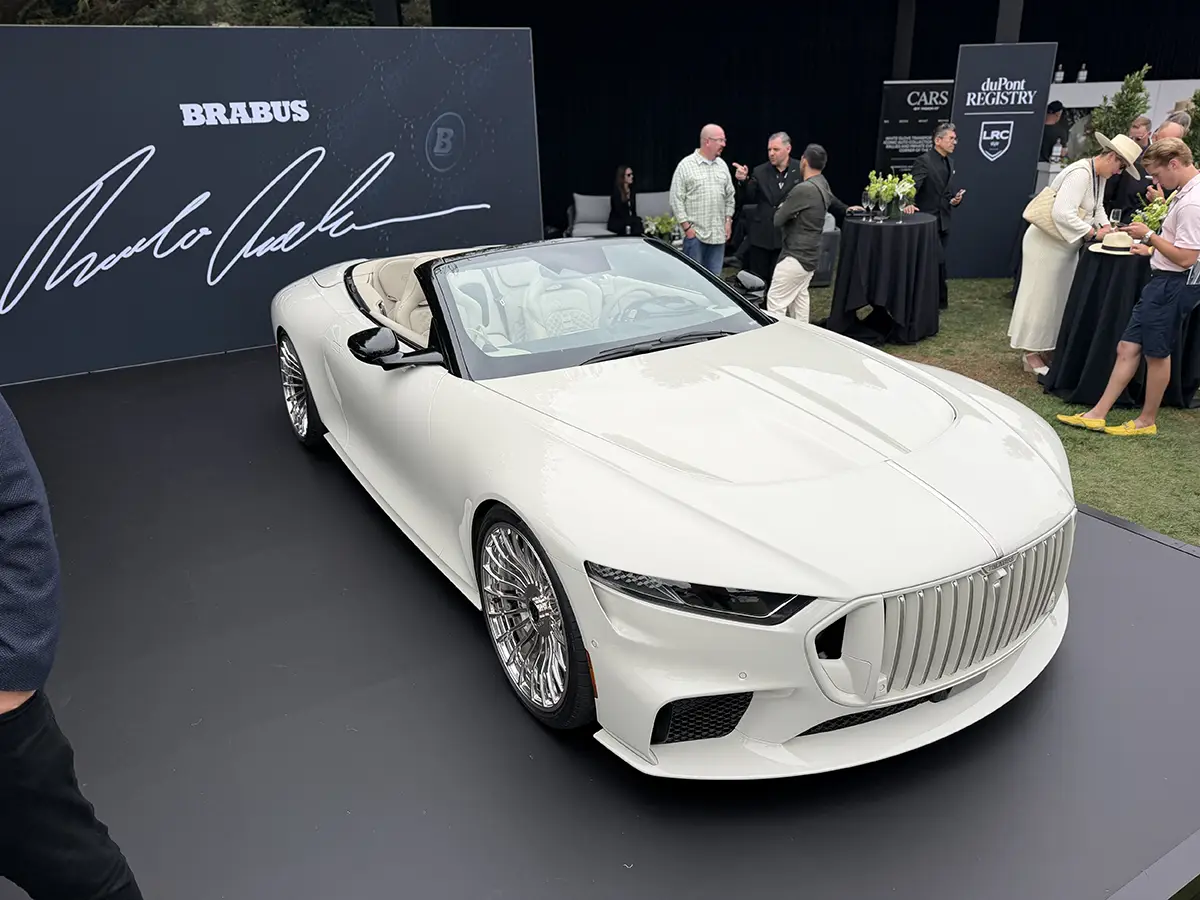 Schrägansicht von vorne auf das weisse Brabus Bodo Cabrio mit offenem Verdeck und markantem Kühlergrill.