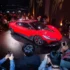 Roter Elektro-Supersportwagen Nebula Next 01 Jet Edition bei der Weltpremiere vor fotografierenden Journalisten auf einer abgedunkelten Showbühne