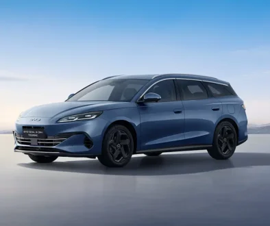 Blaugrauer Mittelklasse-Kombi BYD Seal 6 DM-i Touring Plug-in-Hybrid in der schrägen Seitenansicht auf einer Freifläche im Tageslicht.