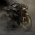 Aston Martin Brough Superior AMB 002 Roadster Superbike in dunkler Frontansicht im Studiorauch mit eingeschaltetem Scheinwerfer.