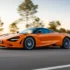 McLaren 750S in kräftigem Orange bei dynamischer Kurvenfahrt auf einer Landstraße. Foto: McLaren